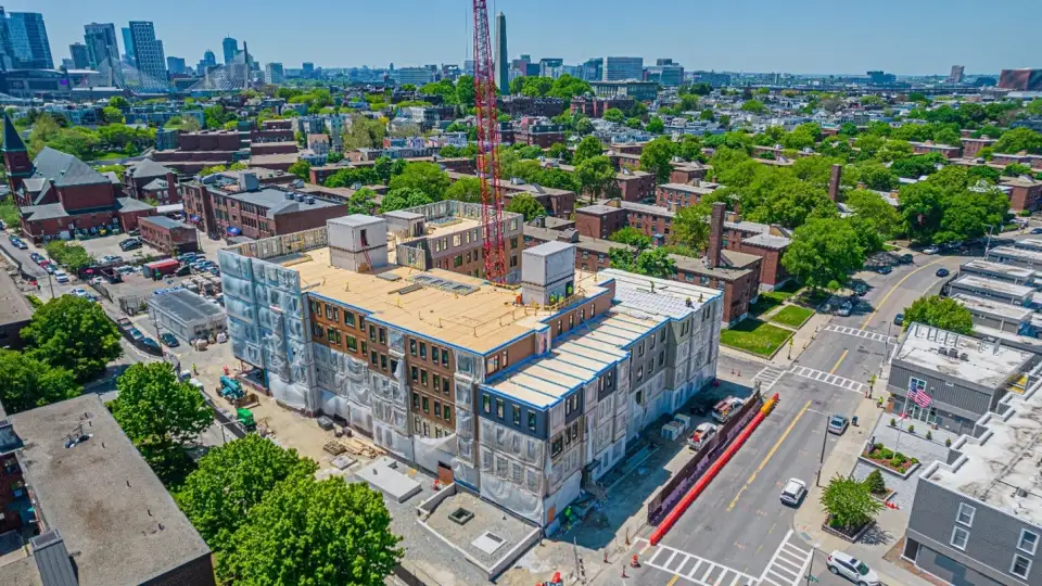 Figure 1. The Building M kit of parts: precast concrete cores, 62-foot CLT floor panels, and load-bearing exterior wall panels.